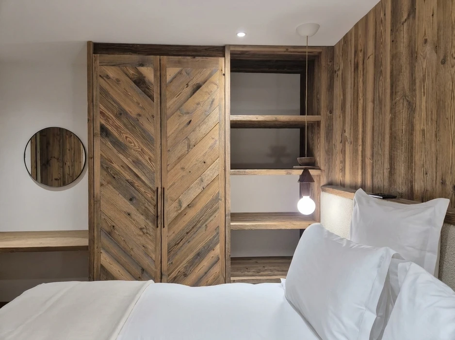 Chambre d'hôtel rustique chic avec armoire à doubles portes en bois massif récupéré à motif chevron
