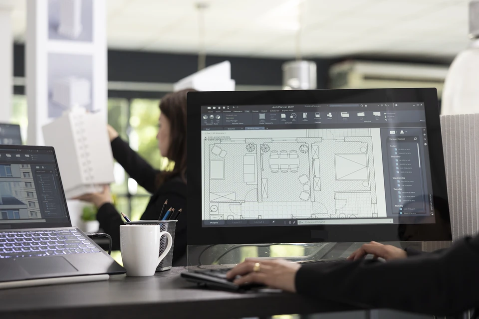 Un homme travaille dans un bureau moderne, concentré sur la création 3D